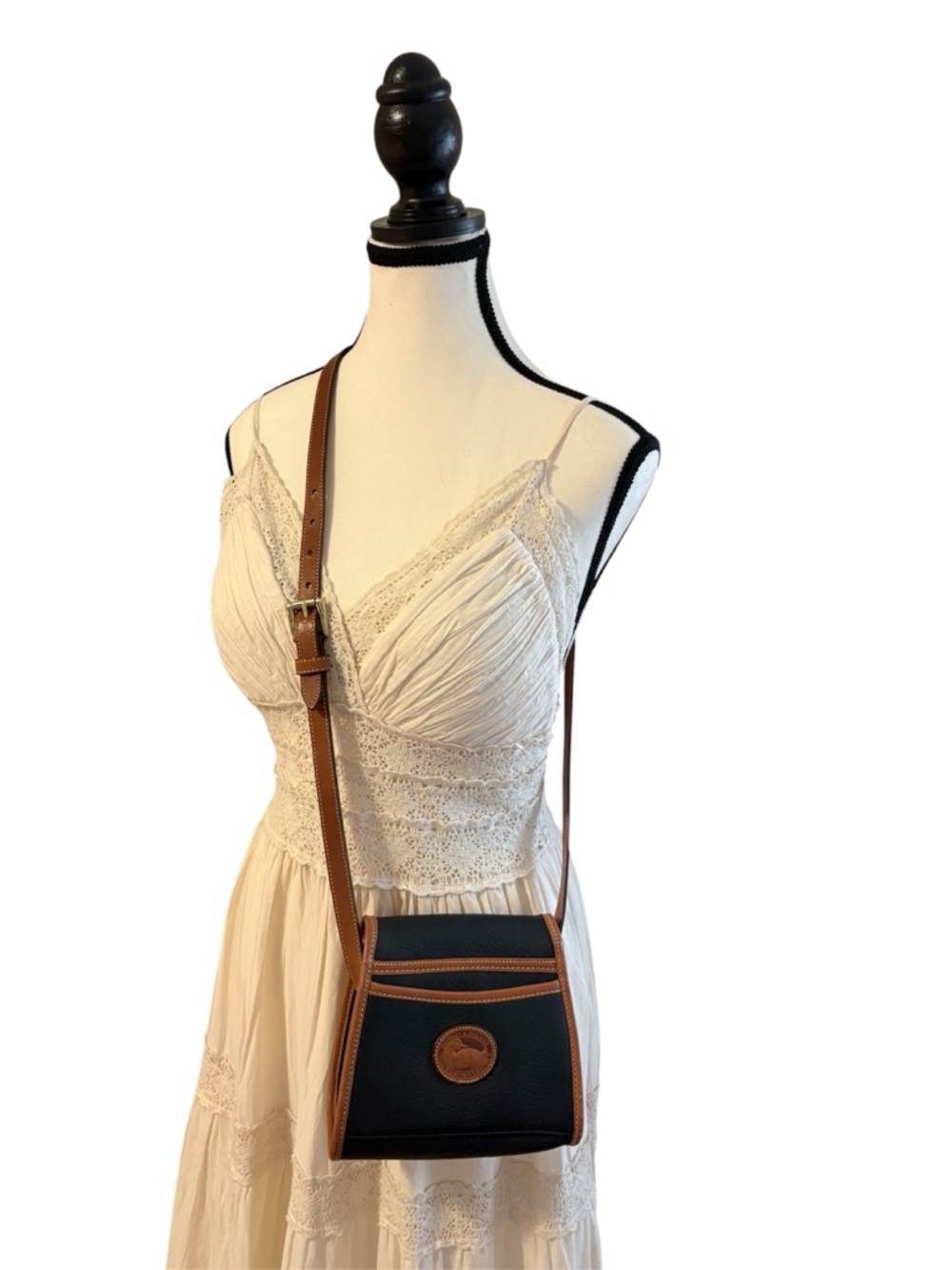 Authentic  Dooney and Bourke Crossbody Bag with Brown Trim and Adjustable Strap